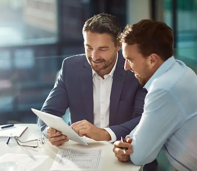 two male realtors looking at a tablet