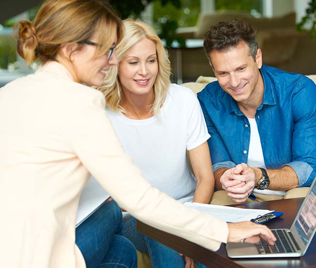 middle aged couple consulting with their Realtor