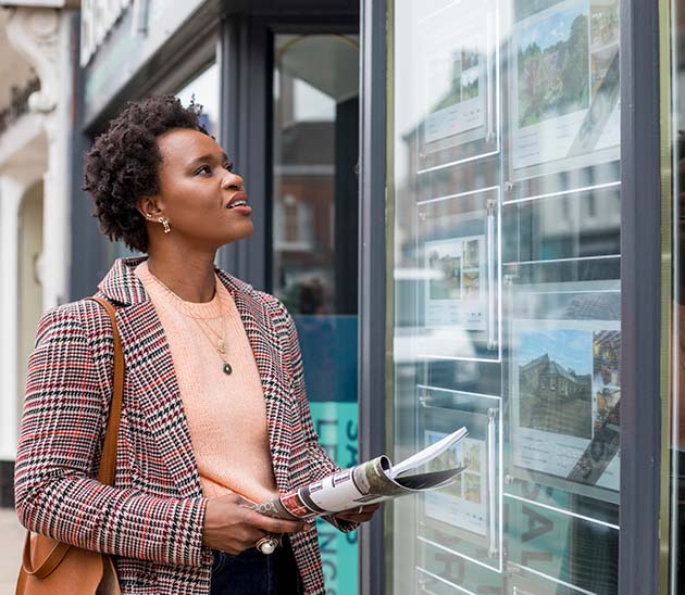 REBBA woman looking at available real estate for sale at a brokerage