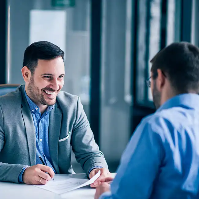 Real estate legal issues being discussed between two male lawyers in a boardroom