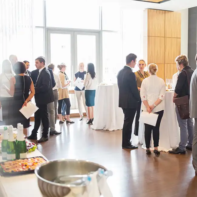 groups of people networking in an event ballroom at a conference