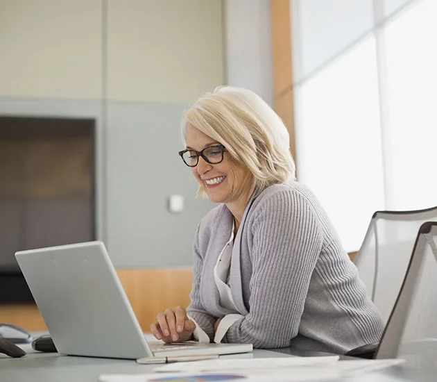 Blonde female real estate salesperson working on Ontario real estate forms in a boardroom.